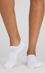 White low-cut no-show socks worn on both feet, with soft ribbed knit cuffs and a smooth fit.