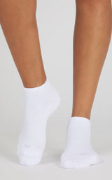 White low-cut socks worn on feet, with a smooth knit texture and ankle-baring fit.