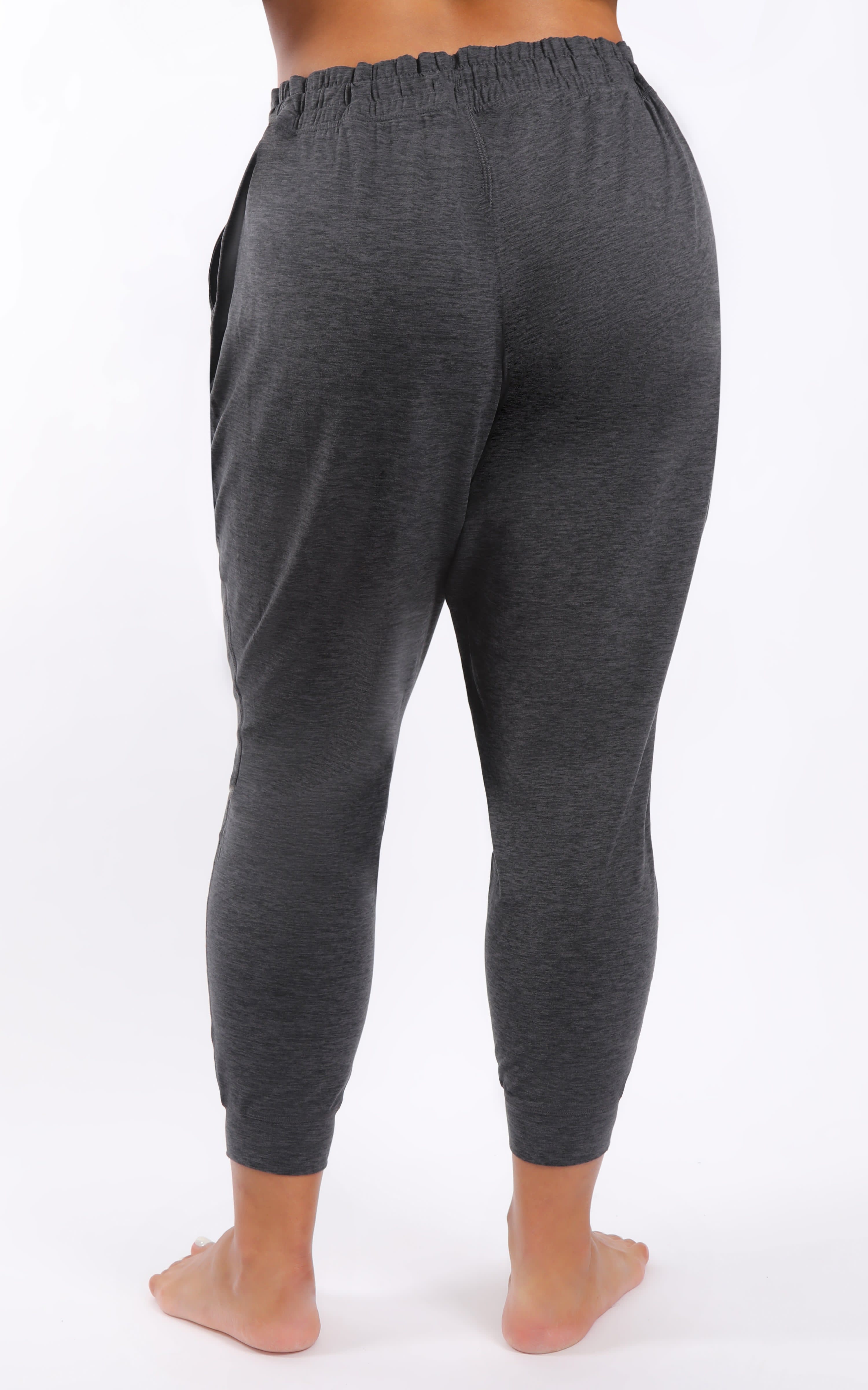Plus size slim ankle joggers in dark heather charcoal with elastic waistband and side pockets.