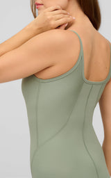 Sleeveless ribbed romper in muted green with scoop back and fitted silhouette.