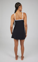Black sleeveless tech dress with white trim and square neckline, shown from back.