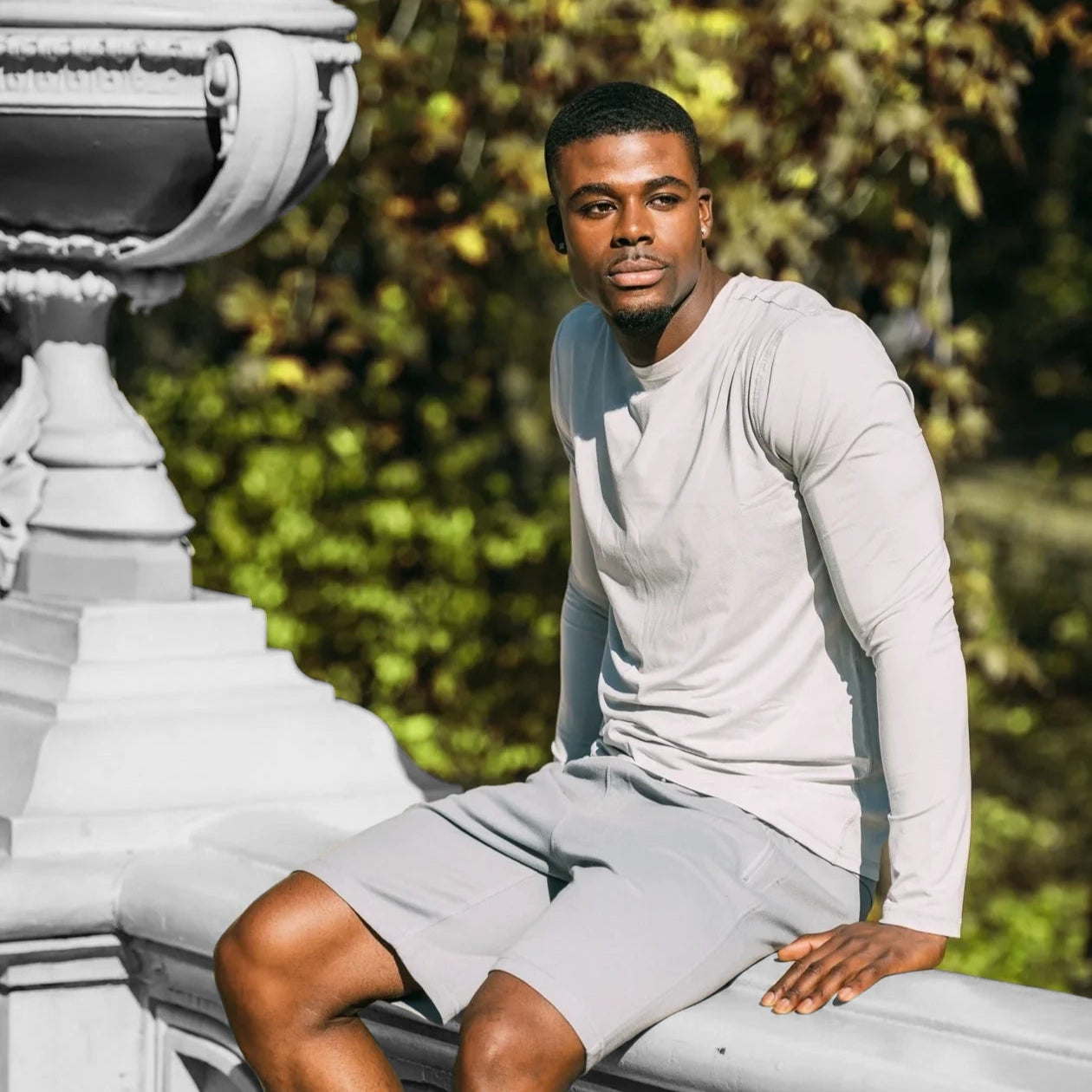 Men's light grey crew neck long sleeve shirt paired with matching shorts outdoors.