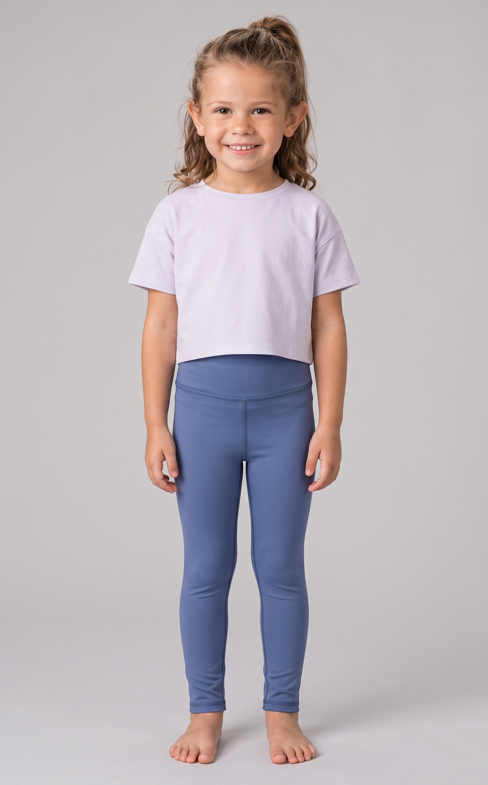 Little girl wearing full-length, dusty blue leggings with a smooth, stretchy fabric and a high waistband.