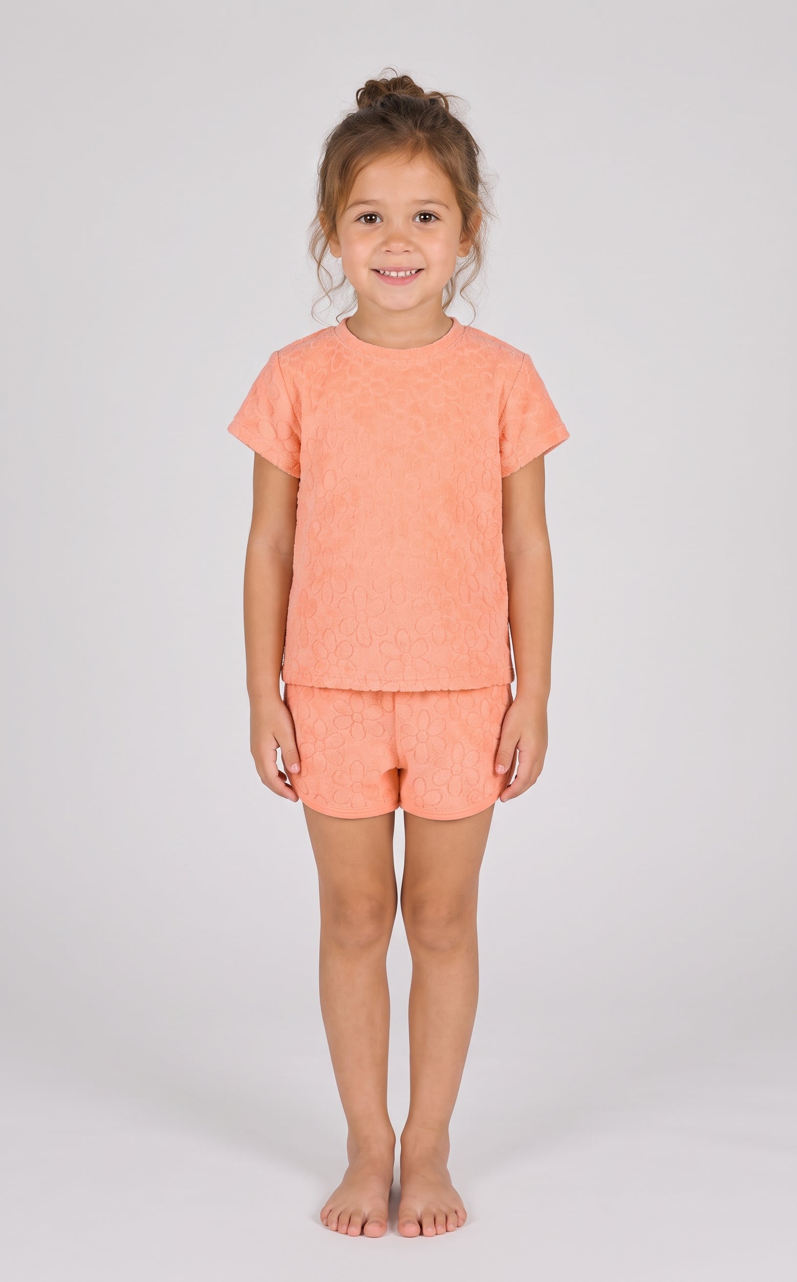 Coral pink toddler girls’ two-piece set with short-sleeve towel terry top and dolphin shorts.