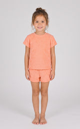 Coral pink toddler girls’ two-piece set with short-sleeve towel terry top and dolphin shorts.