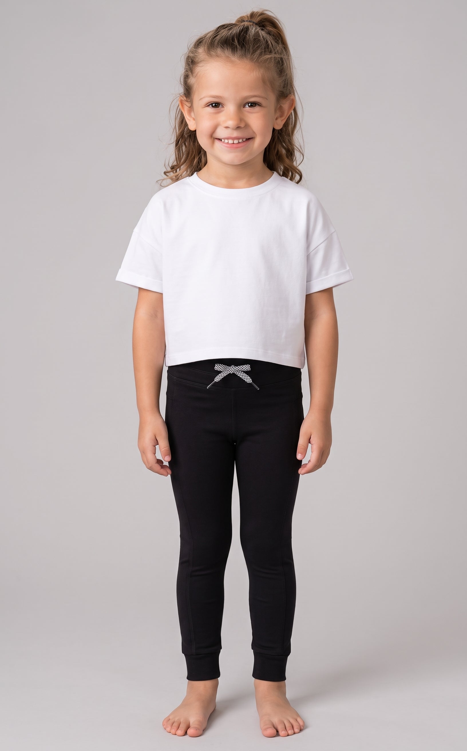 Black high waist jogger leggings for girls with a grey bow detail at the waist.