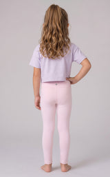 Back view of a girl wearing full-length pale pink leggings with a cropped lavender T-shirt.