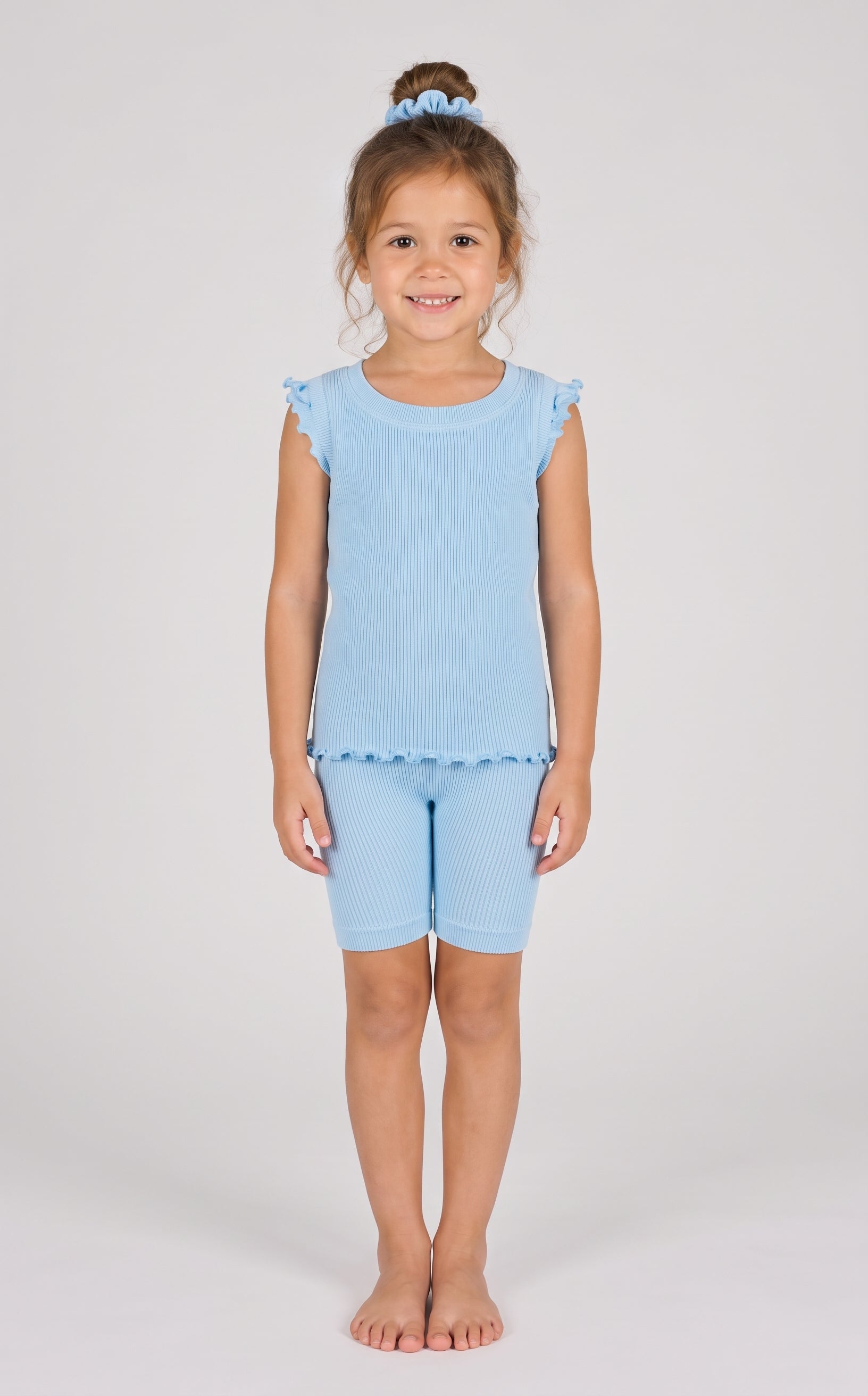 Light blue ribbed ruffle cap sleeve tank with matching biker shorts and scrunchie on a smiling girl.