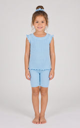 Light blue ribbed ruffle cap sleeve tank with matching biker shorts and scrunchie on a smiling girl.