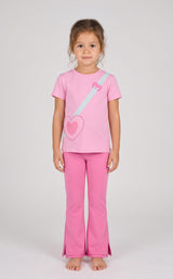 Toddler girl wearing pink short sleeve tee with heart and strap graphic, paired with matching pink flare leggings with front