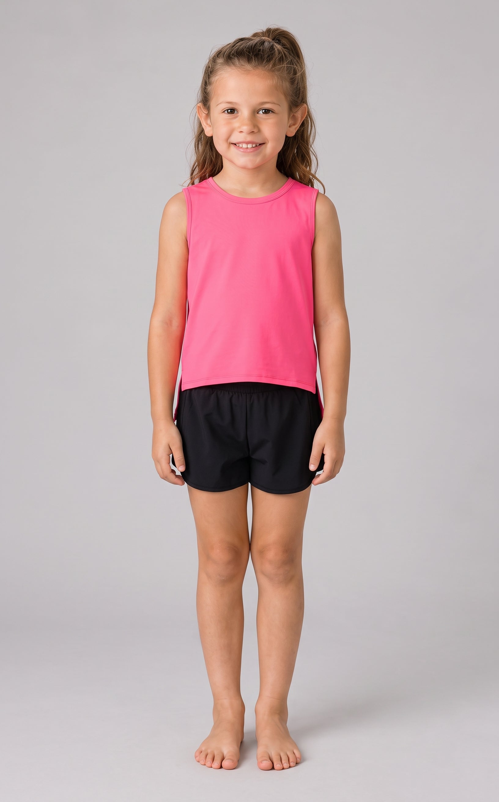 Girls cropped tank tops in bright pink and black, sleeveless with round necklines.