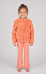 Toddler girl wearing a soft orange jacquard bomber jacket with matching flare leg pants.