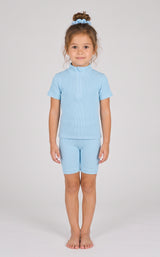 Light blue ribbed seamless short-sleeve top and matching shorts set with a scrunchie on a little girl.