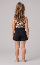 Back view of a girls’ two-piece set with a leopard-print tank and black crossover shorts.