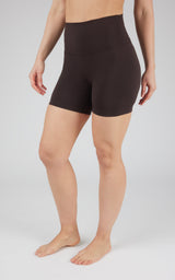 Black high-waisted 5-inch biker shorts with a smooth, fitted design on a standing model.