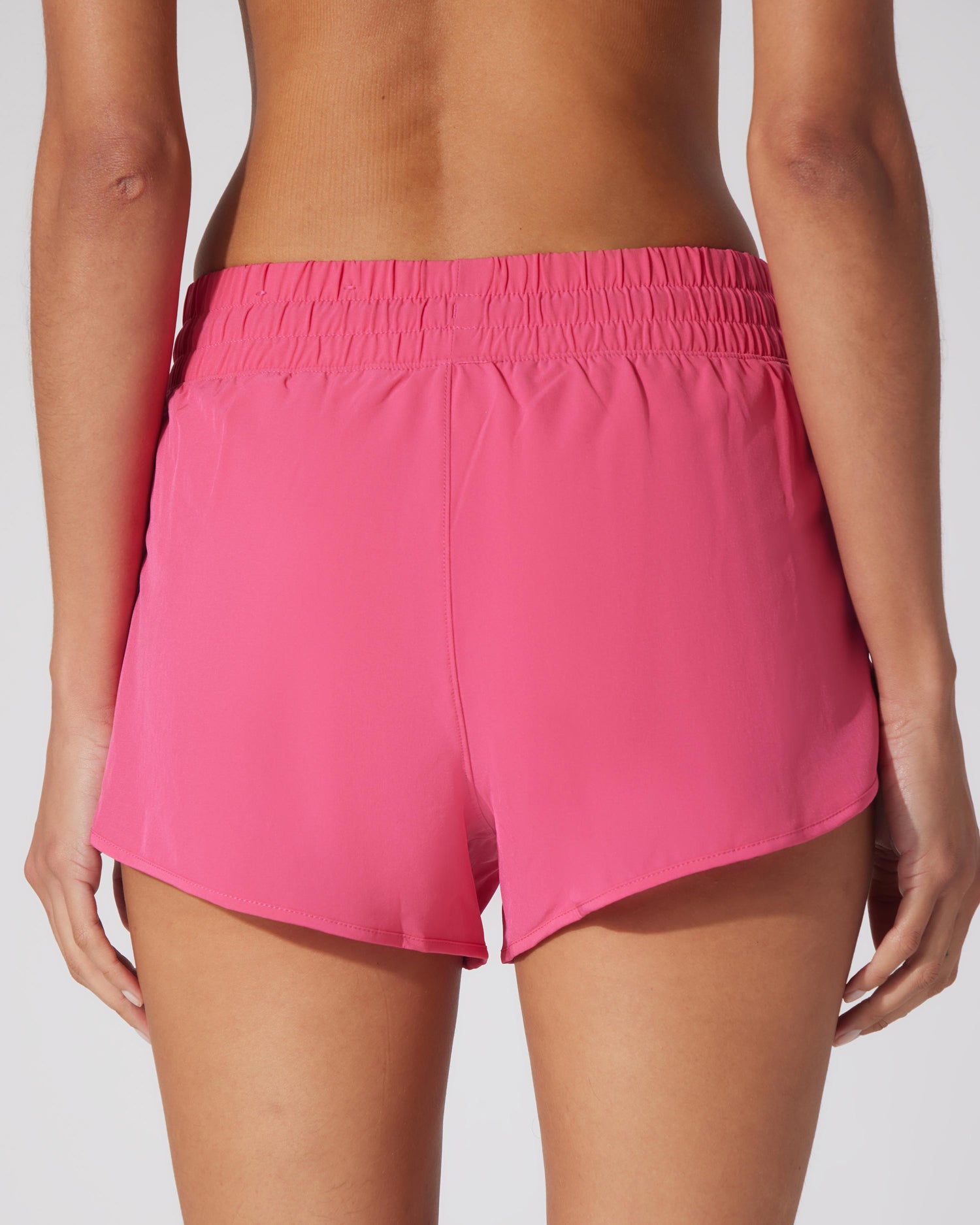 Women's lightweight Raspberry Sorbet running shorts with elastic waistband and curved hem.