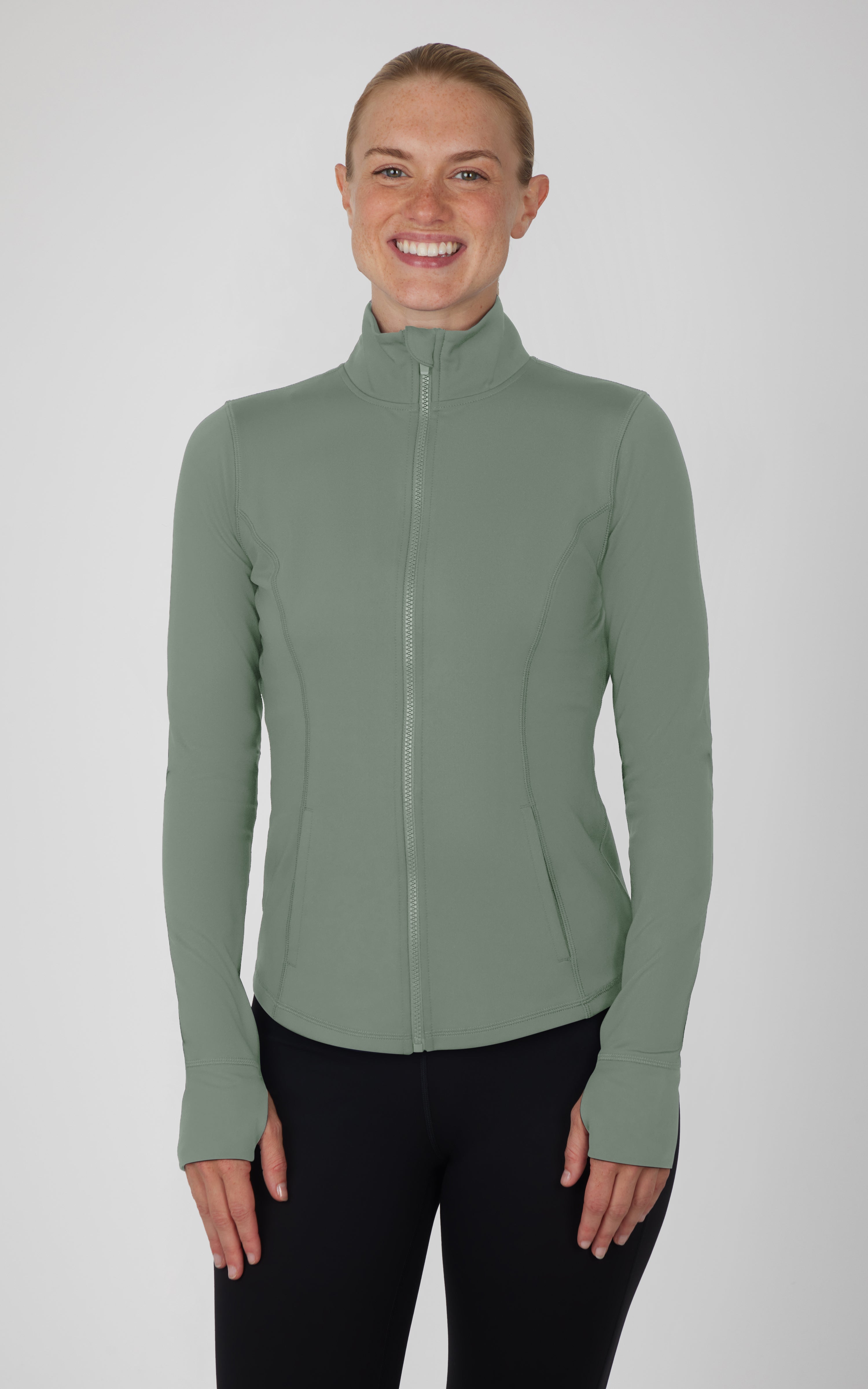 Plus size muted green full zip athletic jacket with thumbholes and high collar.