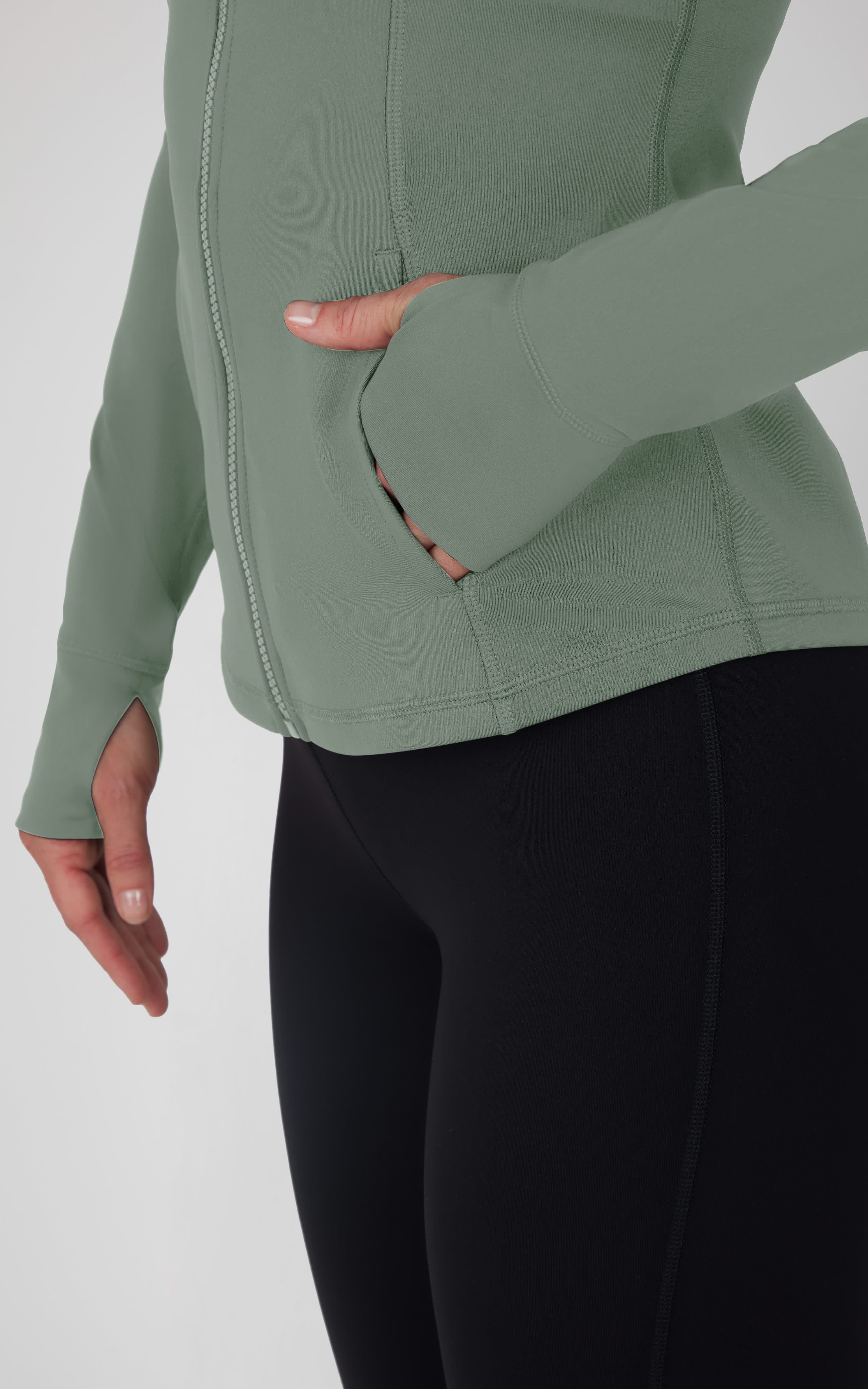 Plus size olive green full zip athletic jacket with thumb holes on long sleeves.