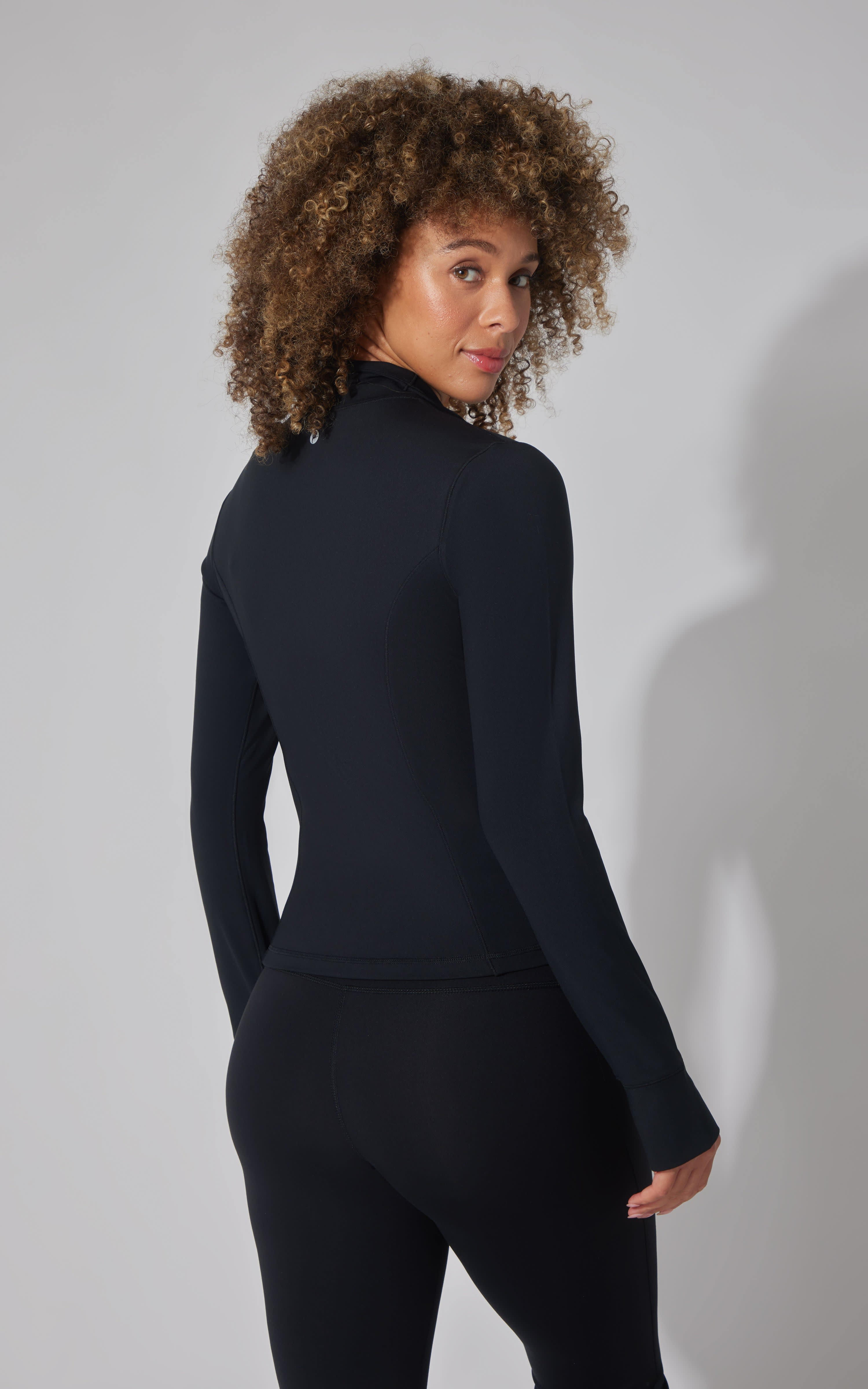 Women's black full-zip interlock jacket with high collar and fitted silhouette, back view.