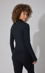 Women's black full-zip interlock jacket with high collar and fitted silhouette, back view.