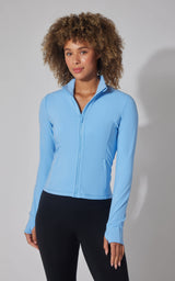 Women's light blue full-zip interlock active jacket with thumb holes and fitted design.
