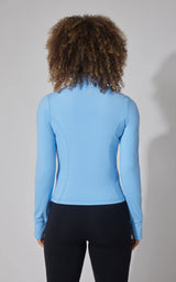 Women's light blue full-zip active jacket with long sleeves and a fitted silhouette.
