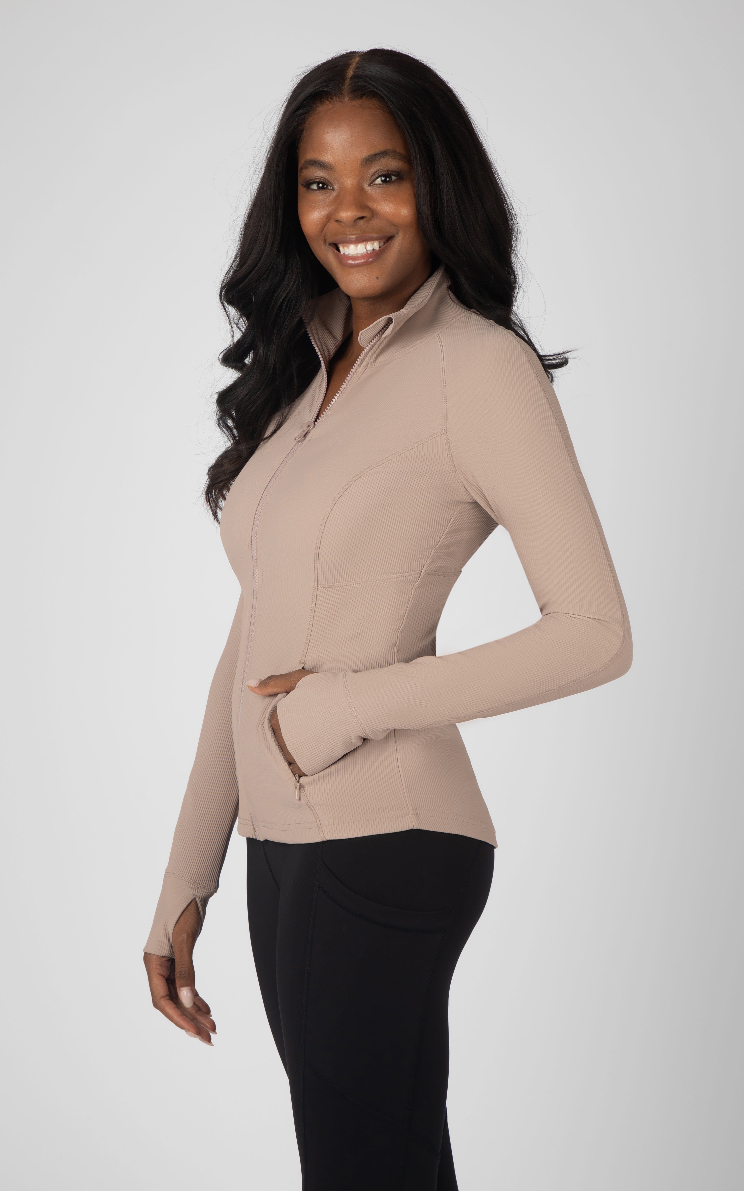 Light brown ribbed full-zip jacket with stand collar, fitted silhouette, and side pockets.