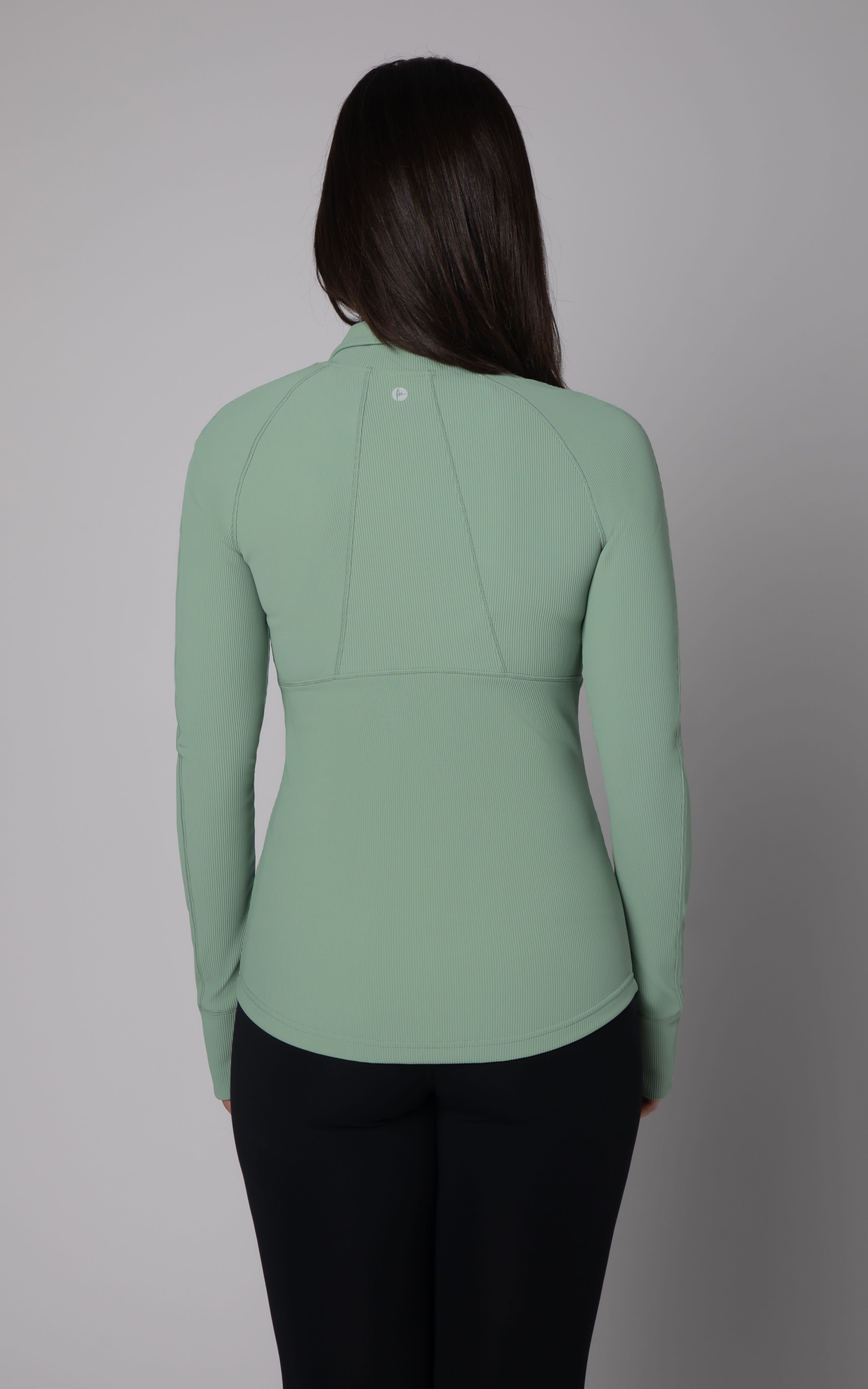 Women's long-sleeve ribbed active jacket in muted green with full zip, fitted silhouette.