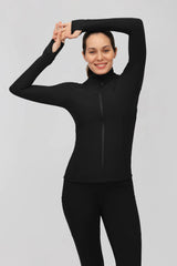Woman wearing a fitted black ribbed full-zip jacket with a mock neck, long sleeves, and thumbholes.