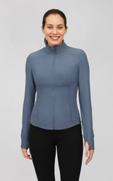 Women’s fitted blue-gray ribbed performance jacket with a mock neck, full zip, and long sleeves.