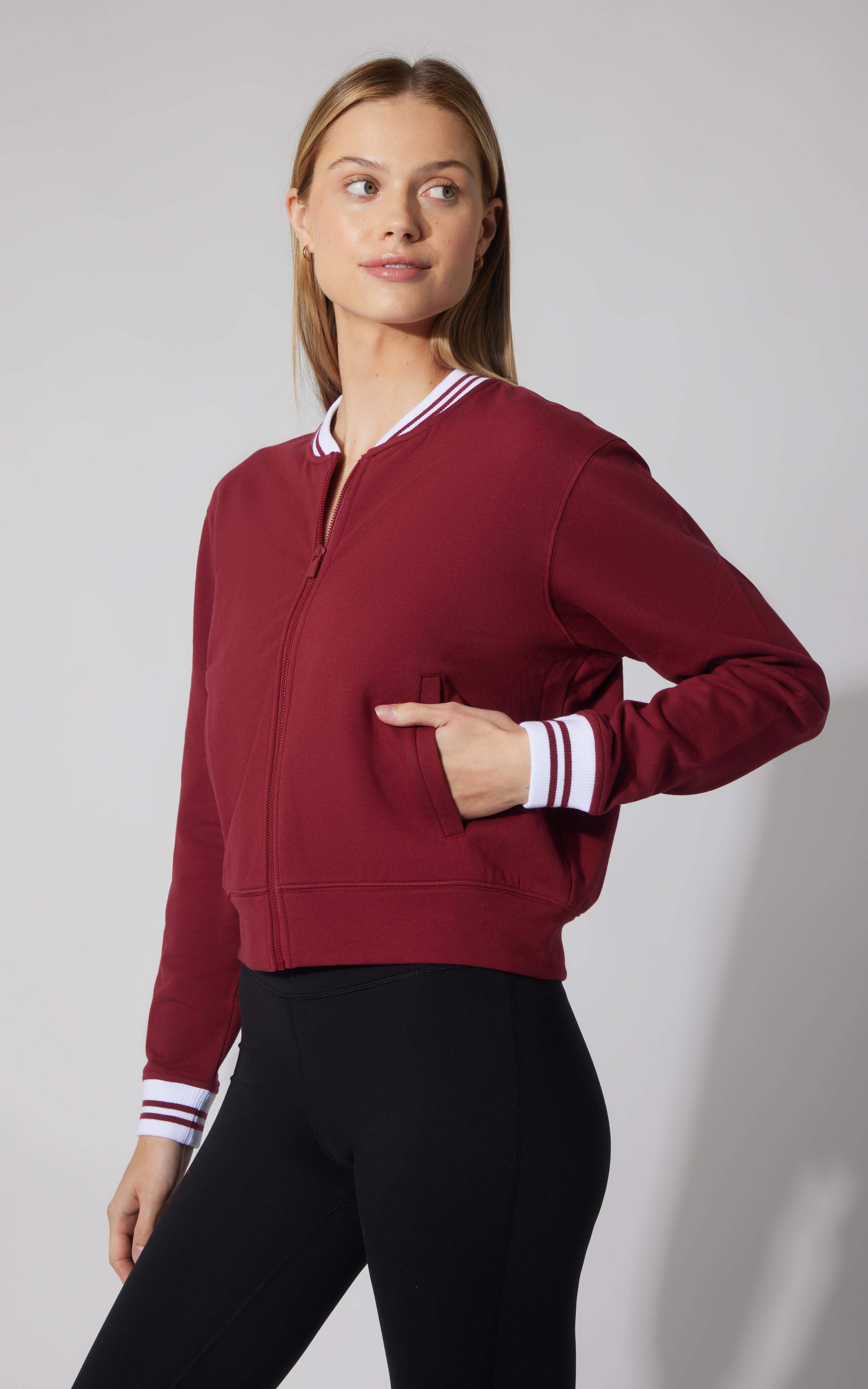 Tibetan red plush bomber jacket with white and red striped ribbed cuffs and collar, full zip front.