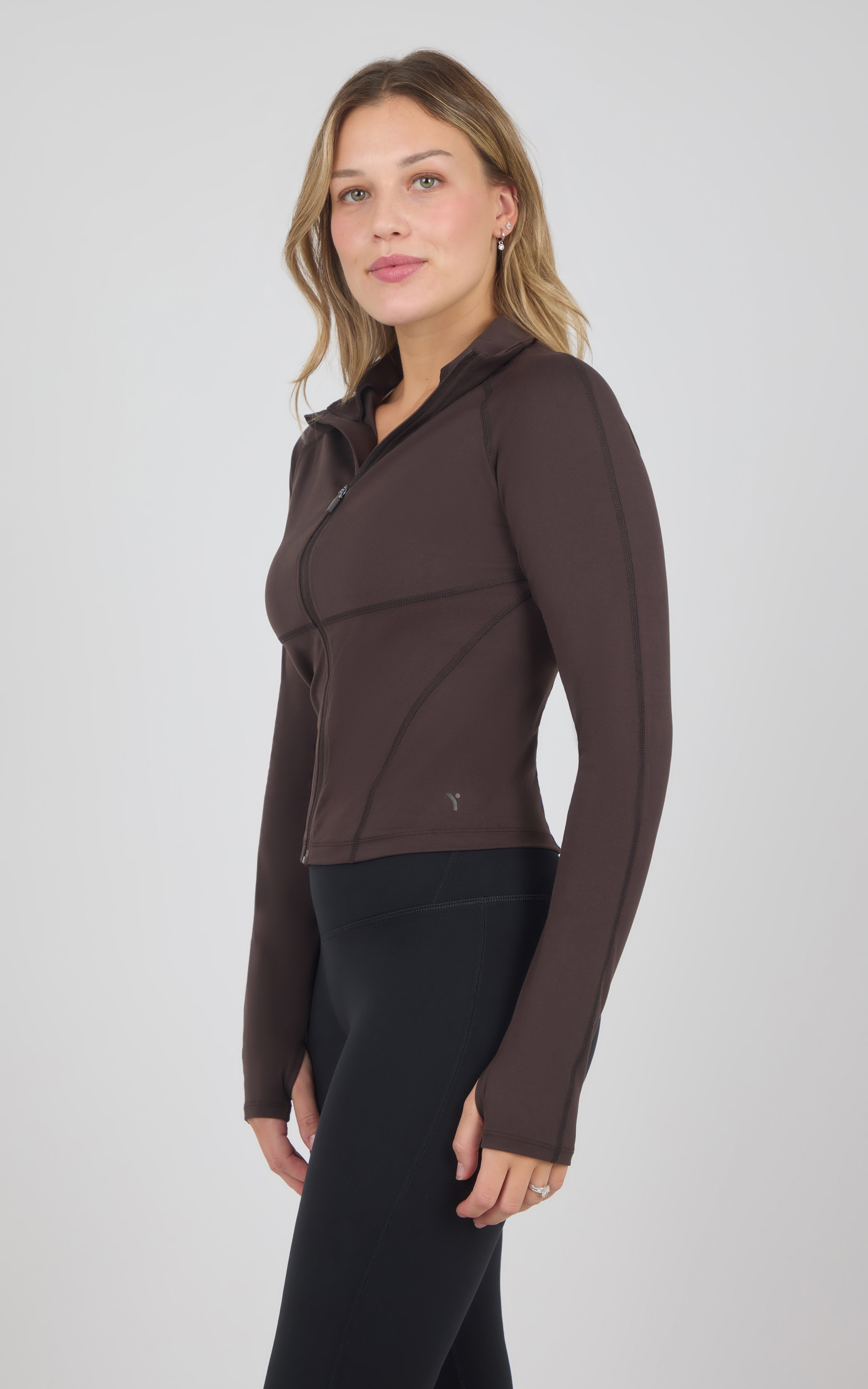 Dark brown full-zip raglan jacket with a high collar, fitted silhouette, and subtle seam detailing.