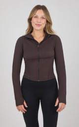Dark brown full-zip raglan jacket with a fitted silhouette, stand collar, and long sleeves, worn with black leggings.