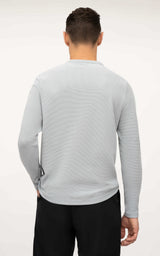 Men's light gray long sleeve Henley shirt with textured fabric and relaxed fit viewed from the back.