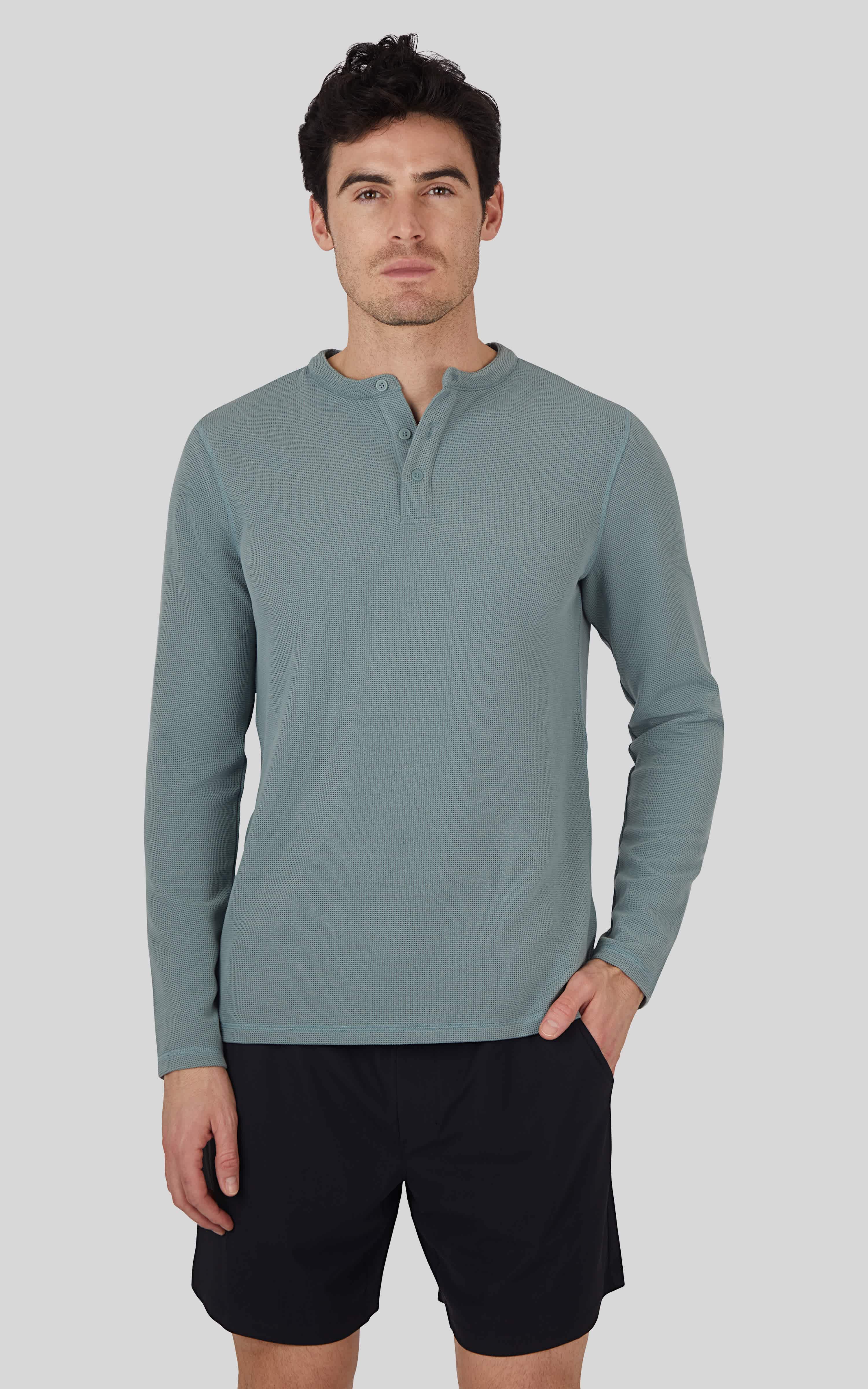 Men's long sleeve henley shirt in stormy sea blue with textured fabric and button placket.