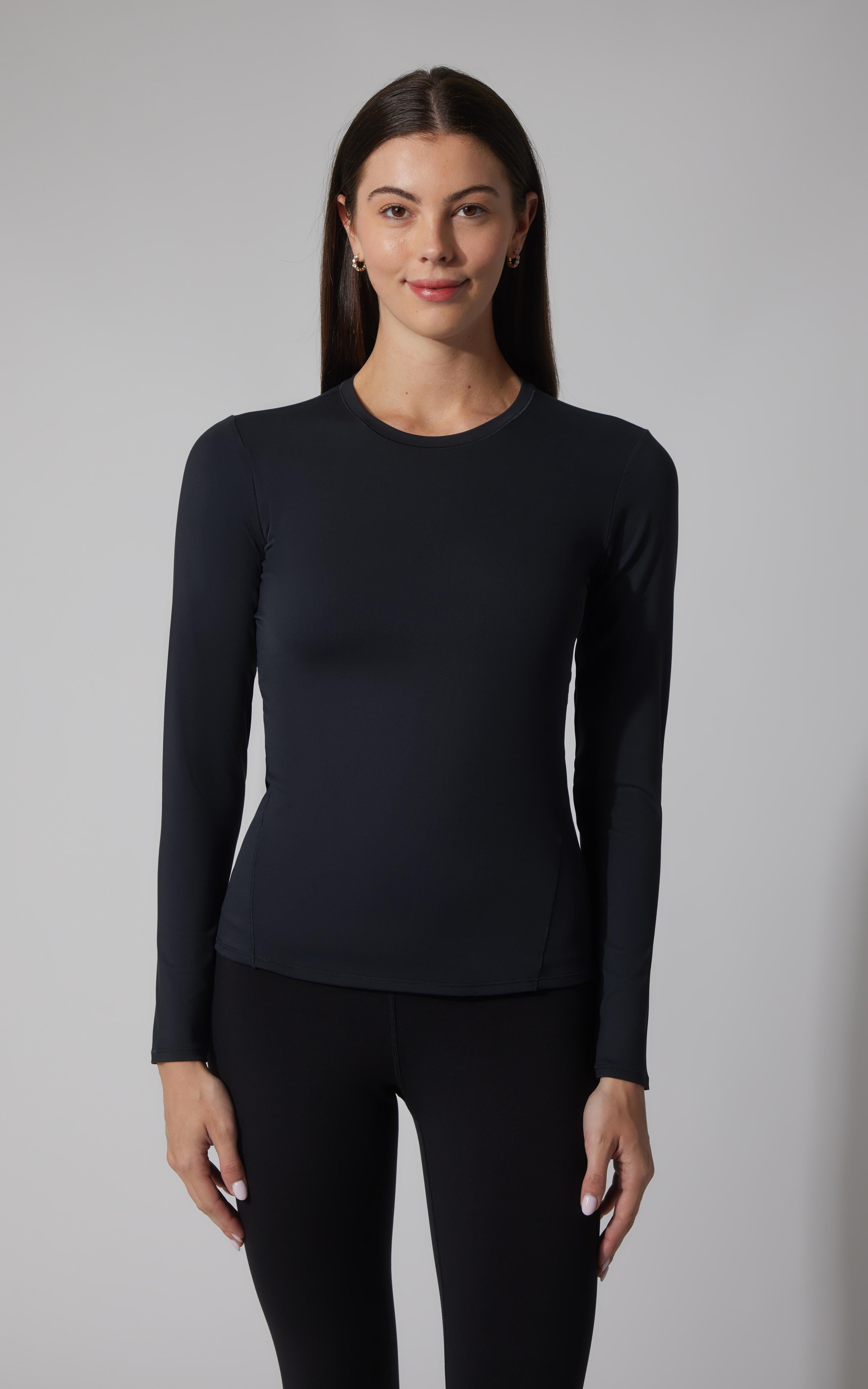 Black fitted long sleeve crew neck top on a woman, smooth fabric, simple design.