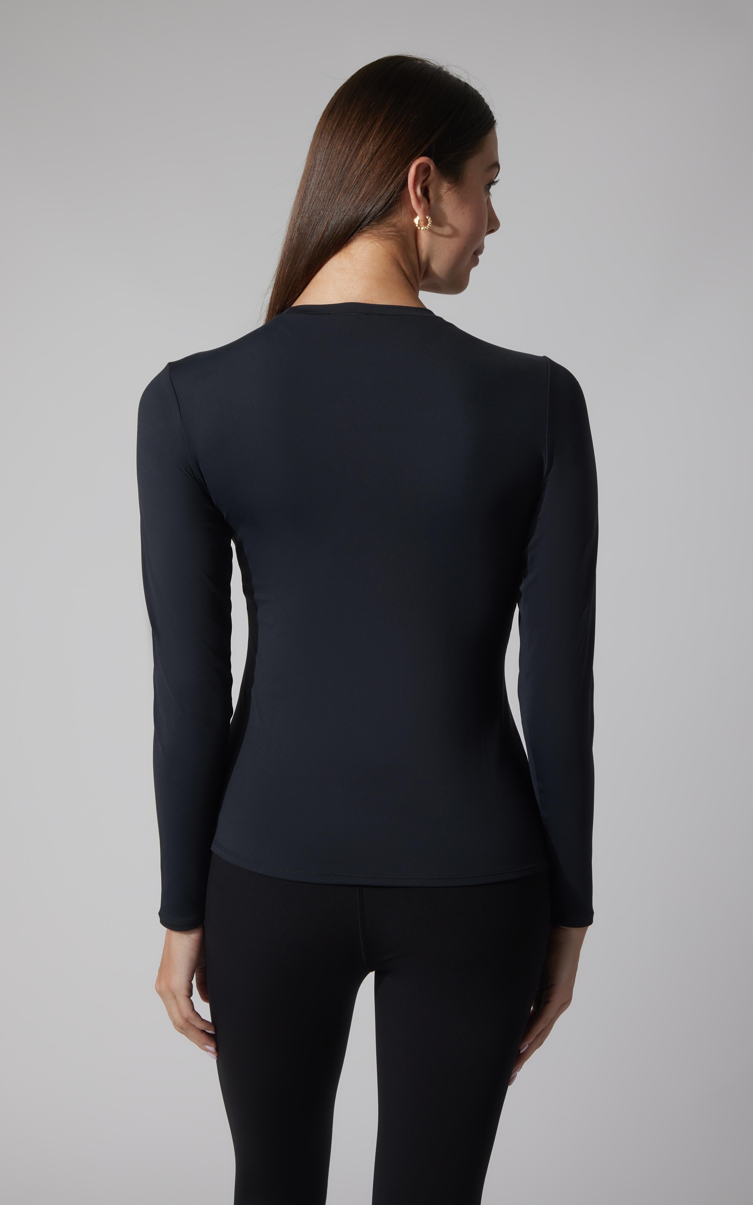 Women's fitted long sleeve top in black with crew neckline and smooth fabric.