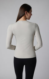 Women's fitted long sleeve top in light gray with crew neckline and smooth fabric.