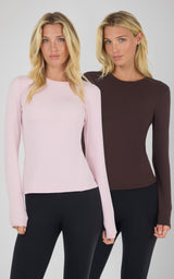 Two women wearing Zenly Zena long sleeve tops in chalk pink and chocolate torte, slim fit with crew necks.