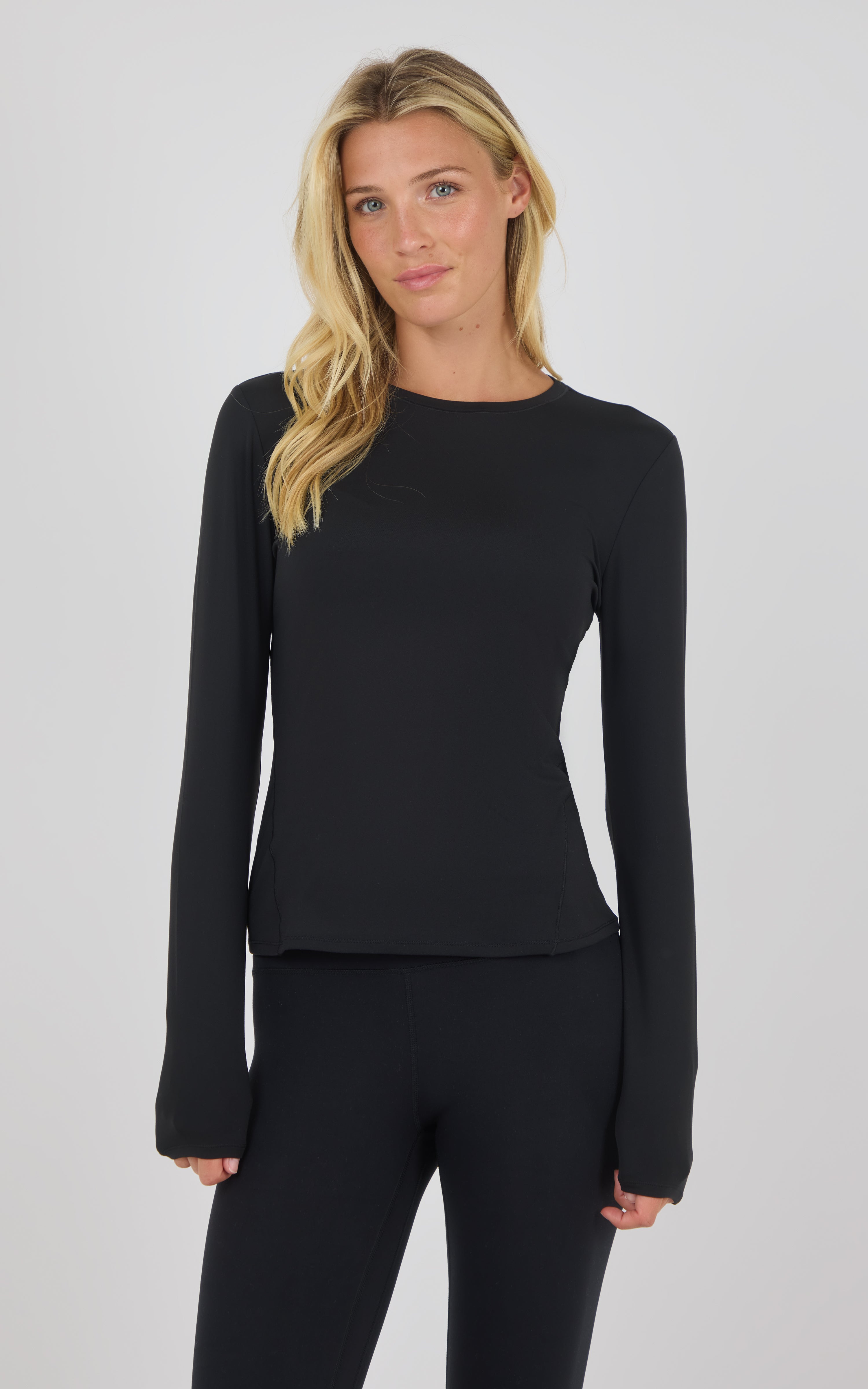 Black long sleeve fitted top with crew neckline and thumbhole cuffs.