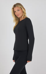 Black long sleeve fitted top with crew neck on female model, side view.