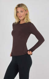 Chocolate brown fitted long sleeve top with crew neckline on female model.