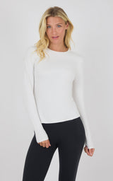 White fitted long sleeve top with crew neck and thumb holes on sleeves.