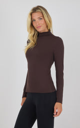 Brown mock neck long sleeve fitted top with smooth texture worn by model.