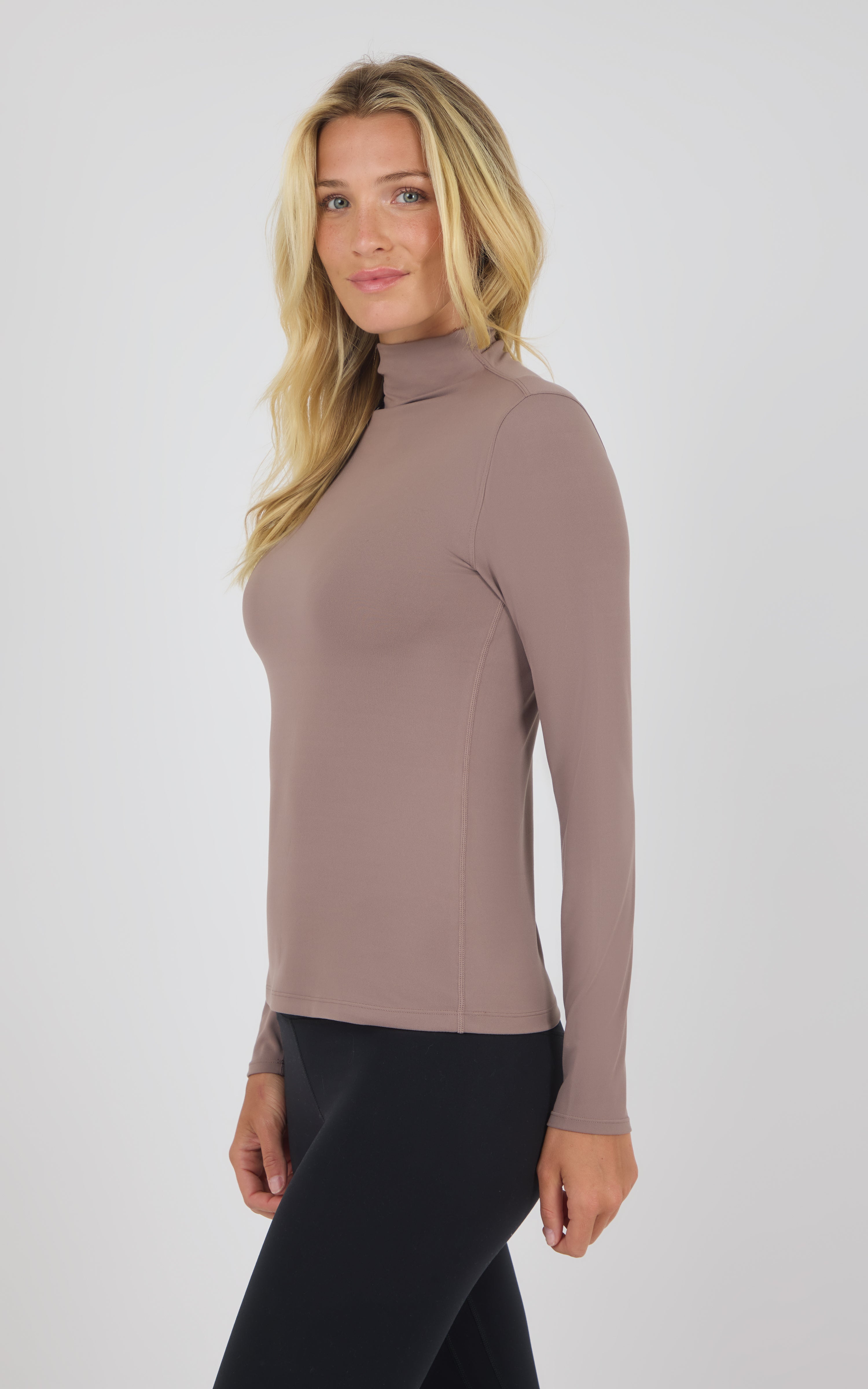 Long-sleeve mock neck top in deep taupe with a slim fit and smooth fabric finish.