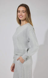 Light gray modal terry long sleeve crewneck top with ribbed cuffs and relaxed fit.