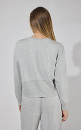 Light gray modal terry long sleeve crewneck sweater with ribbed cuffs and hem, shown from back.