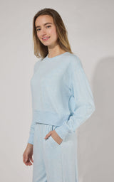 Light blue modal terry crewneck long sleeve top with relaxed fit and ribbed cuffs.