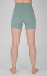 High-waist 5-inch green biker shorts with a smooth, fitted silhouette and seamless waistband.