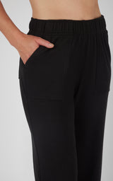 Black marled pique wide-leg pants with elastic waistband and side pocket, women's lounge style.
